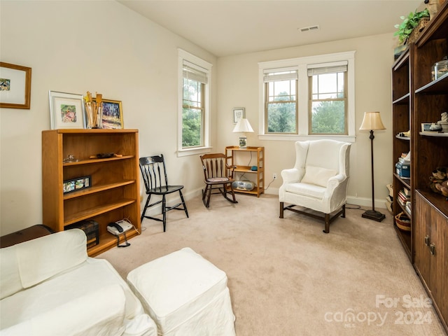 living area with light carpet