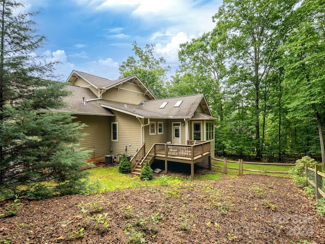 back of house with central AC unit and a deck