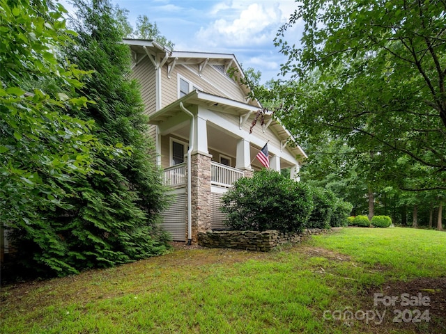 view of home's exterior with a lawn