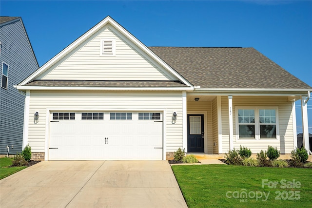 view of front of home with a garage and a front lawn