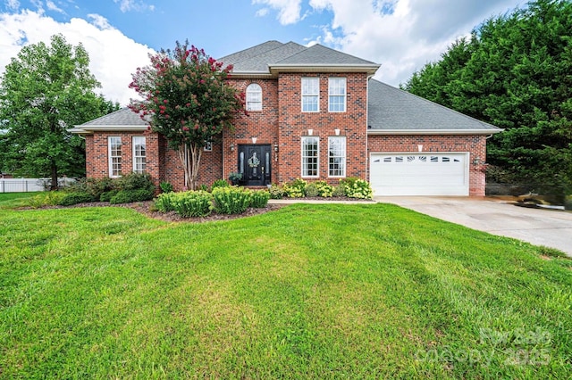 view of front of home with a garage and a front yard