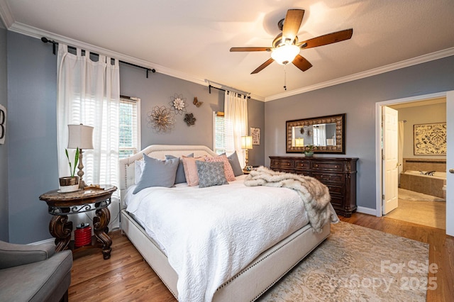 bedroom with ceiling fan, ornamental molding, light hardwood / wood-style floors, and ensuite bath