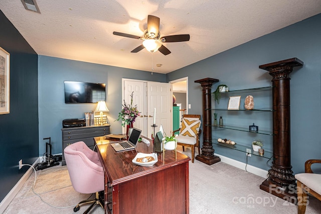 office area featuring ceiling fan, light colored carpet, and a textured ceiling