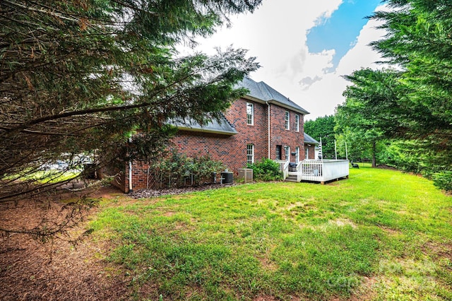 view of yard featuring central AC unit and a deck