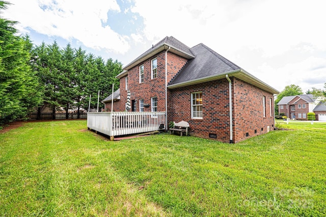 back of house with a wooden deck and a yard