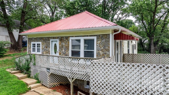 view of side of home with a deck