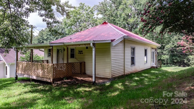 rear view of property with a lawn