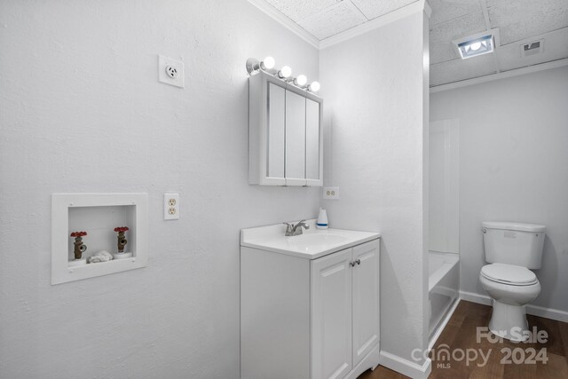 full bathroom with shower / bathtub combination, vanity, hardwood / wood-style flooring, and toilet