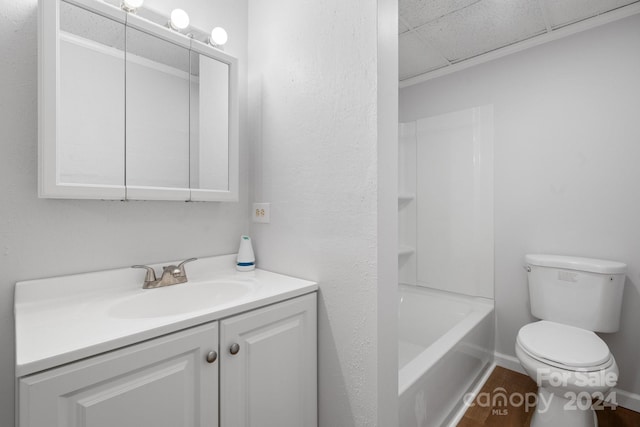 full bathroom with a paneled ceiling, bathtub / shower combination, toilet, vanity, and hardwood / wood-style flooring