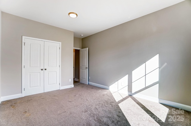 unfurnished bedroom with light carpet and a closet