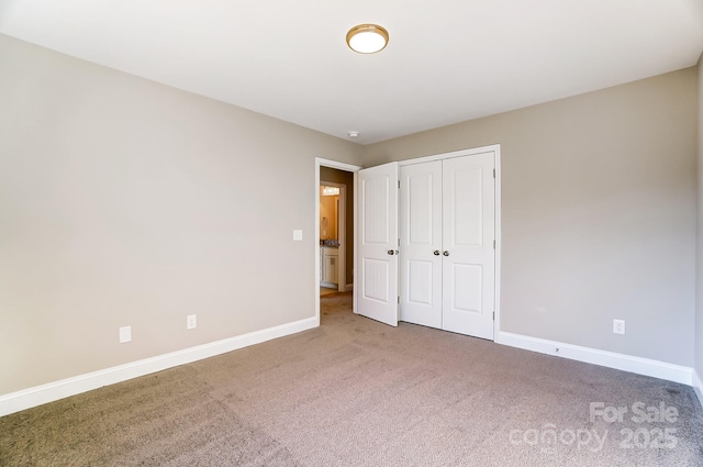 unfurnished bedroom featuring carpet floors and a closet