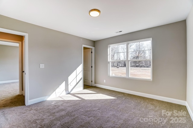 spare room featuring light carpet