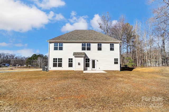 back of house with central AC unit, a patio area, and a yard