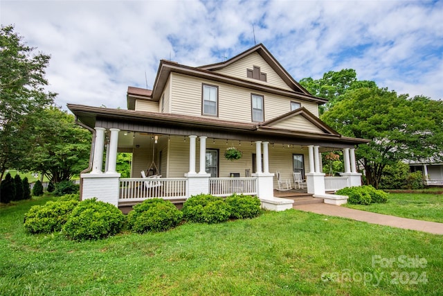 view of front of house featuring a porch and a front yard