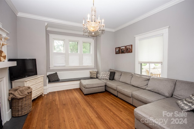 living room featuring an inviting chandelier, light hardwood / wood-style flooring, and ornamental molding