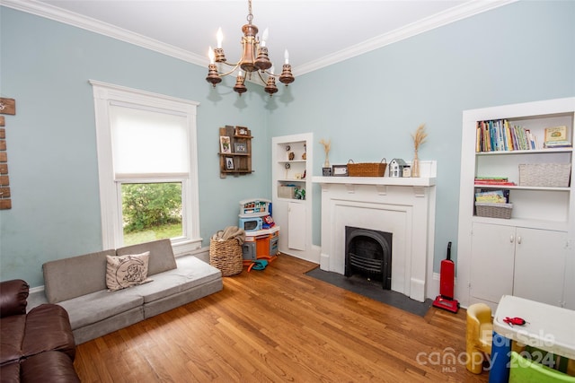 living room with crown molding, hardwood / wood-style flooring, and a chandelier