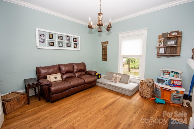 living room with a notable chandelier, light hardwood / wood-style flooring, and ornamental molding