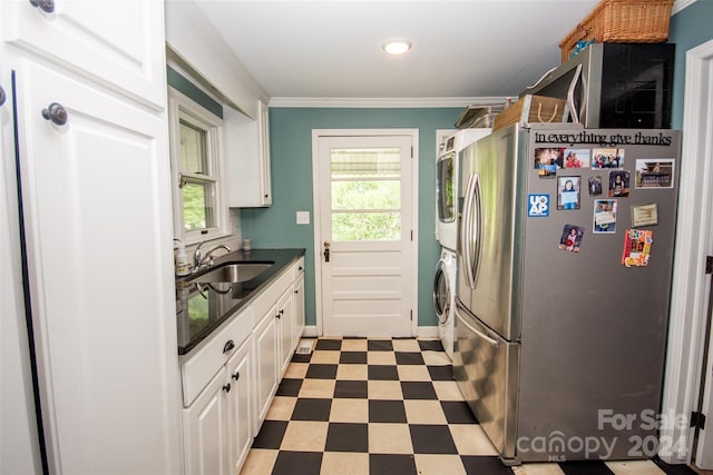 kitchen featuring white cabinets, sink, a wealth of natural light, and stainless steel fridge