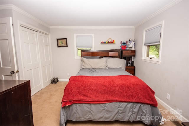 bedroom featuring light carpet, crown molding, and a closet