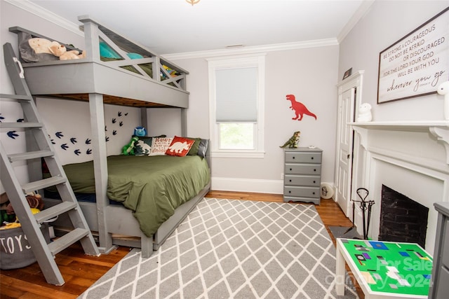 bedroom with crown molding and hardwood / wood-style floors