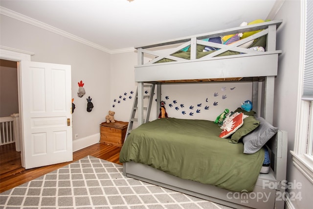 bedroom with wood-type flooring and ornamental molding