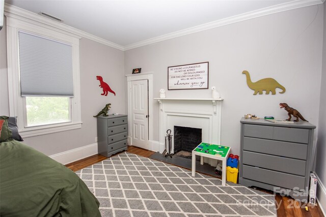 bedroom with crown molding and wood-type flooring