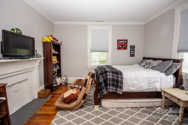 bedroom featuring crown molding and dark hardwood / wood-style floors