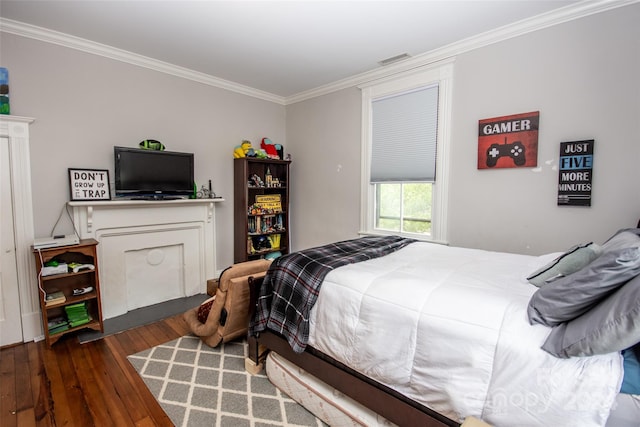 bedroom with crown molding and dark hardwood / wood-style flooring