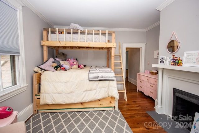 bedroom featuring ornamental molding and dark hardwood / wood-style flooring