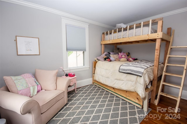 bedroom featuring crown molding and dark hardwood / wood-style floors