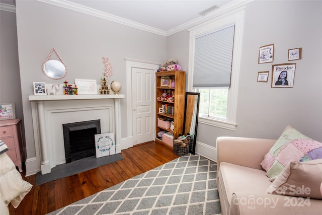 living room featuring ornamental molding and wood-type flooring