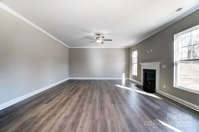 unfurnished living room featuring dark wood-type flooring, ornamental molding, and ceiling fan