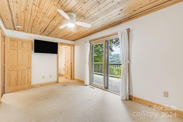 unfurnished bedroom with wooden ceiling, carpet flooring, visible vents, baseboards, and access to outside