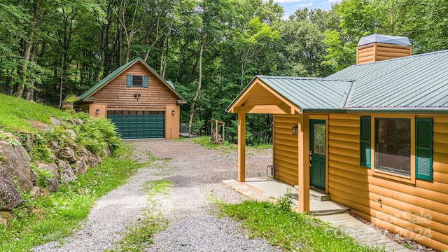 detached garage featuring a forest view