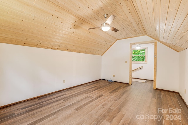 additional living space featuring wooden ceiling, light wood finished floors, ceiling fan, and vaulted ceiling