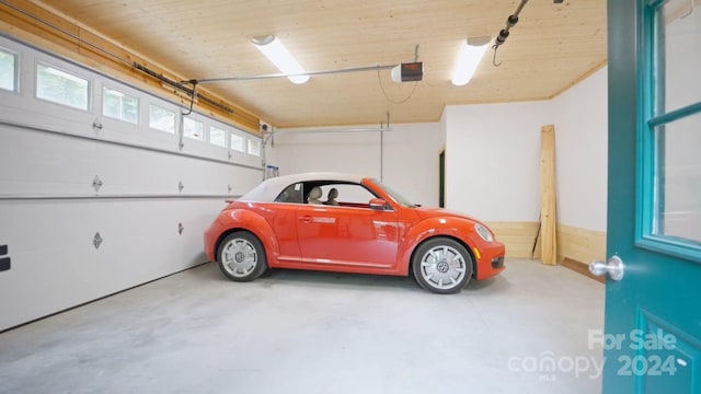 garage with a garage door opener and wooden ceiling