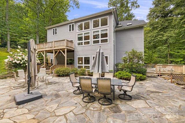 back of house featuring a deck