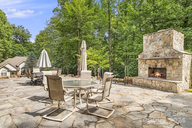 view of patio / terrace featuring an outdoor stone fireplace