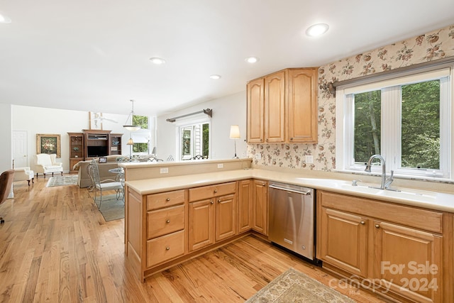 kitchen featuring sink, dishwasher, kitchen peninsula, and light wood-type flooring