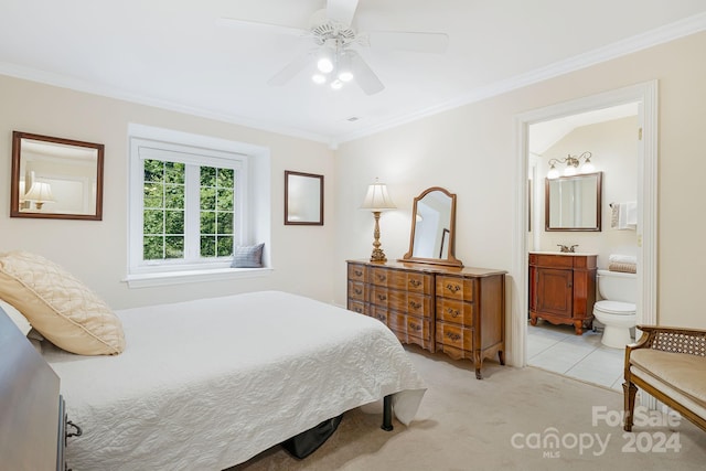 carpeted bedroom featuring connected bathroom, ornamental molding, and ceiling fan