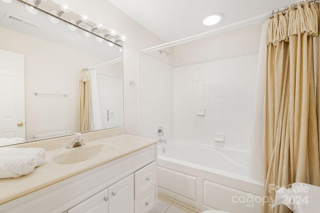 full bathroom featuring tile patterned floors, vanity, toilet, and shower / tub combo with curtain