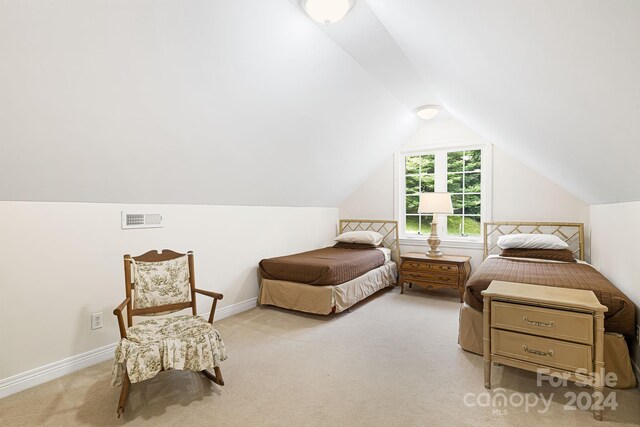 living area featuring light carpet and vaulted ceiling