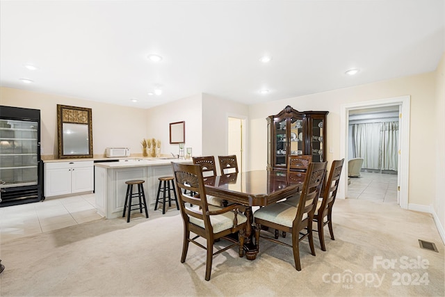 dining area with light colored carpet