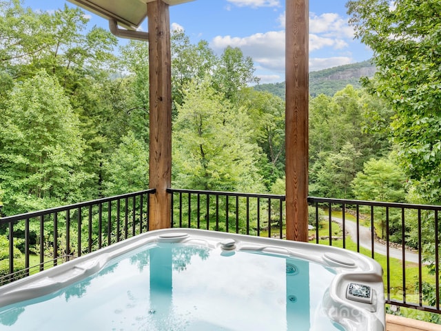 view of pool with a hot tub