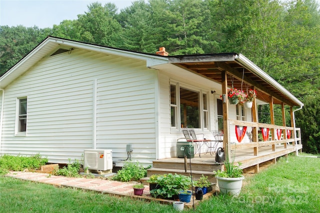 view of side of home featuring covered porch