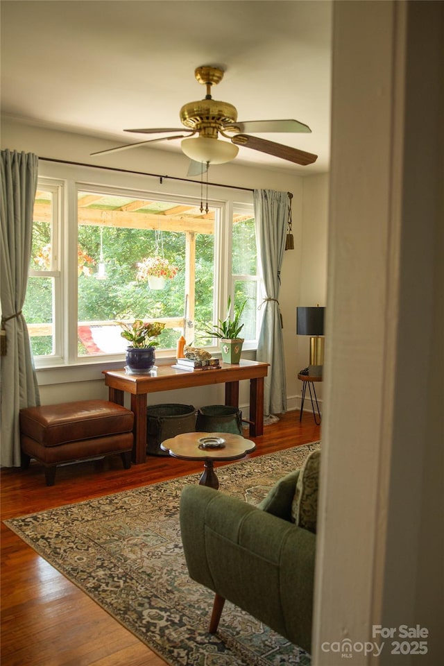 living area featuring wood finished floors and a ceiling fan