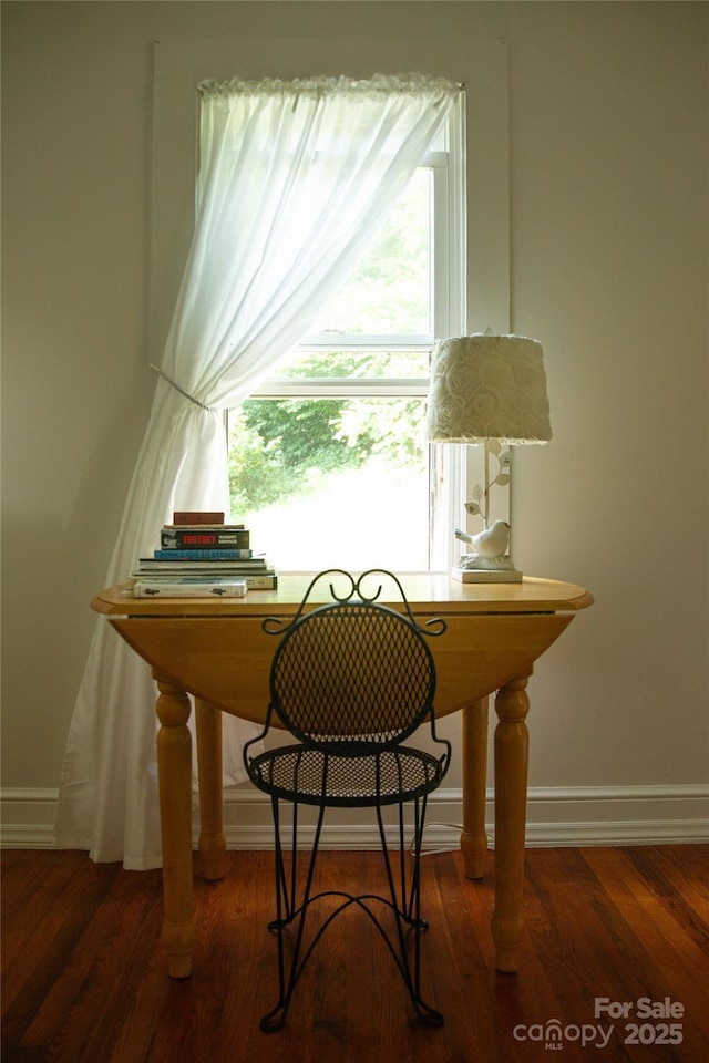 home office featuring baseboards and wood finished floors