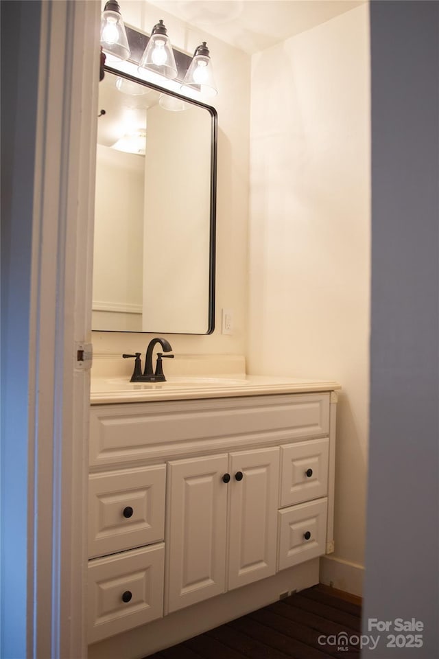 bathroom with vanity and wood finished floors