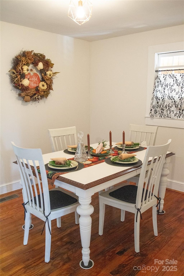 dining area featuring visible vents and wood finished floors