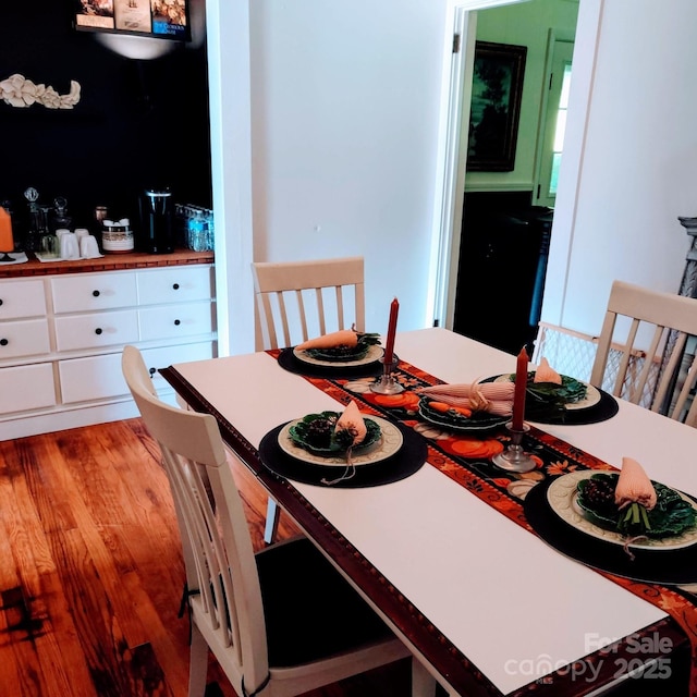 dining area with wood finished floors